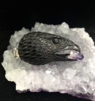 Raven Carving Holding Amethyst Pendant